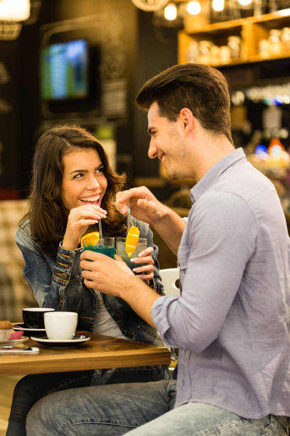 istock Young couple sharing cocktails in bar 1190207979