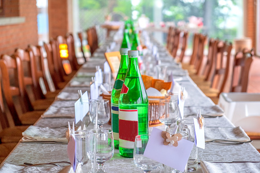 restaurant invitation prepared table long with glass waters bottles cover charge .