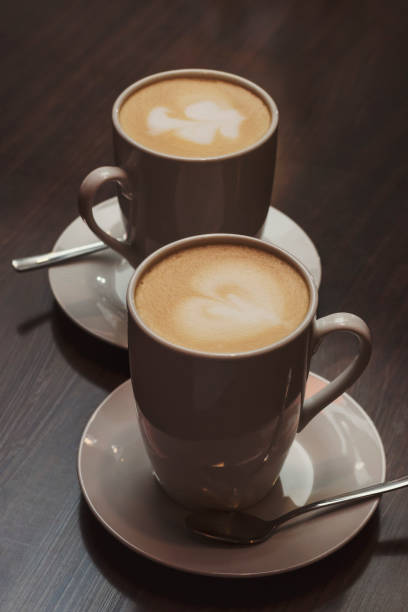 istock Two cups of lattes in a dark cafe. 1190210084