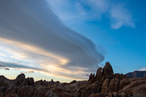 istock Sierra Wave lenticular cloud formation over desert rock landscape 1190211057
