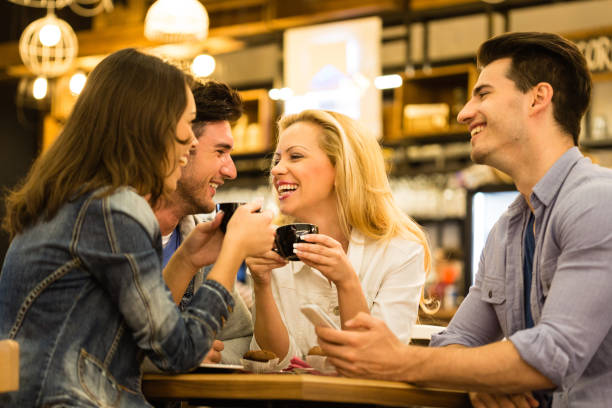 istock Four young adults drinking coffe and chatting 1190211735