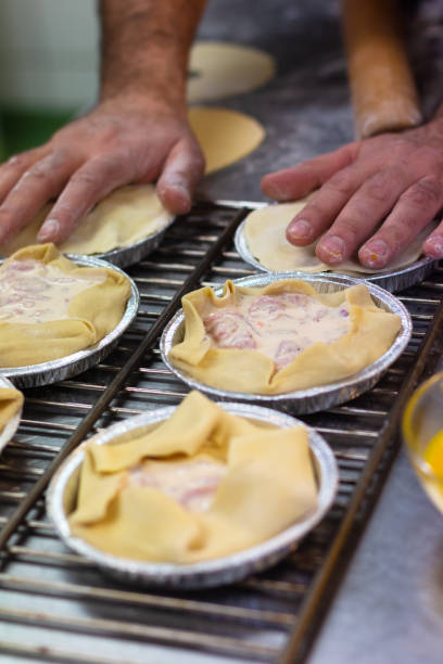 istock Food preparation concept action making ham cream pie with copy space 1190213123