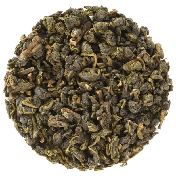 High grade dry Taiwan tea. Dazuan Organic Ying Xiang Amber Magpie Taiwan Oolong Tea in round shape isolated on white background