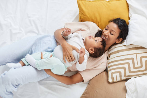 istock Mother lying with child in the bed 1190214770