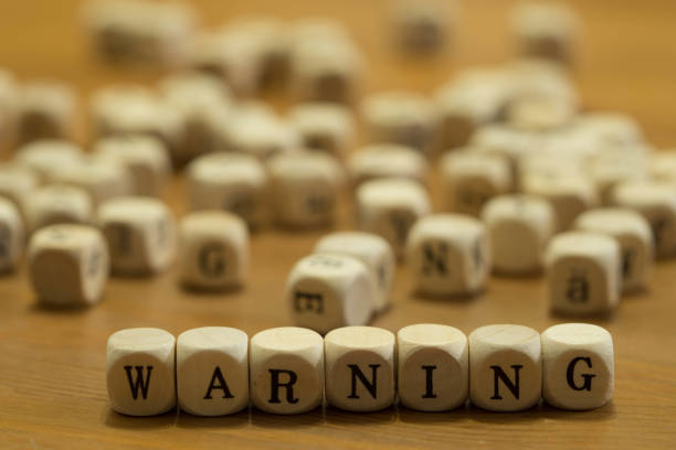 istock warning written with wooden cubes 1190216248
