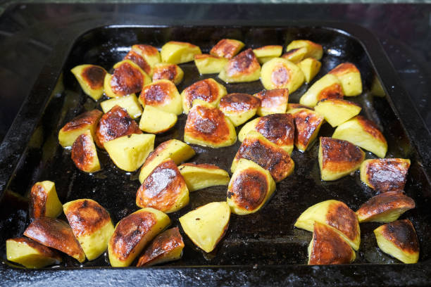 istock Golden baked potatoes with herbs from the oven 1190219821