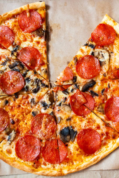 istock Slices Pizza pepperoni with tomatoes and mushrooms. 1190221211