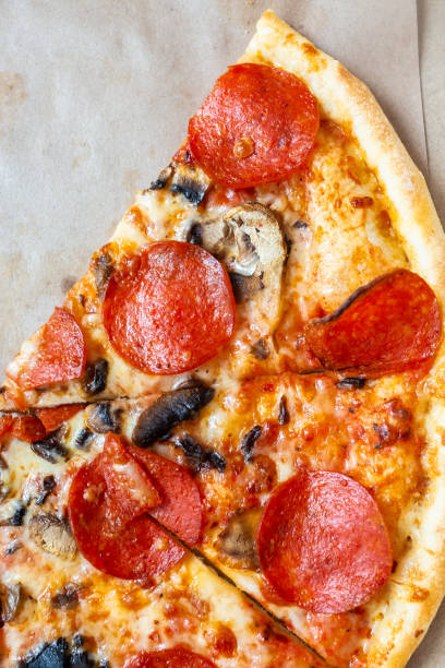 istock Slices Pizza pepperoni with tomatoes and mushrooms. 1190221219