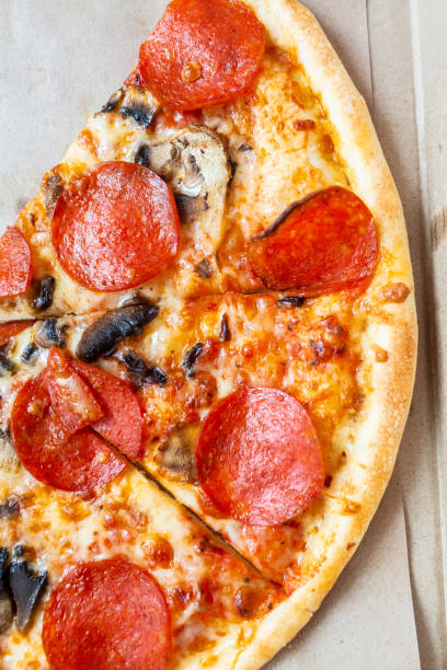 istock Slices Pizza pepperoni with tomatoes and mushrooms. 1190221708