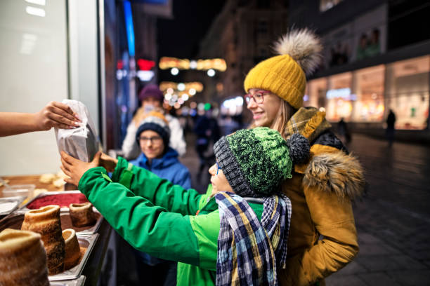 Family buying traditional Czech Trdelnik cakes Kids buying at the Czech street bar.  Brothers and sister are buying traditional fresh baked cake - Czech Trdelnik. Brno old town, Czech Republic.
Nikon D850 trdelník stock pictures, royalty-free photos & images