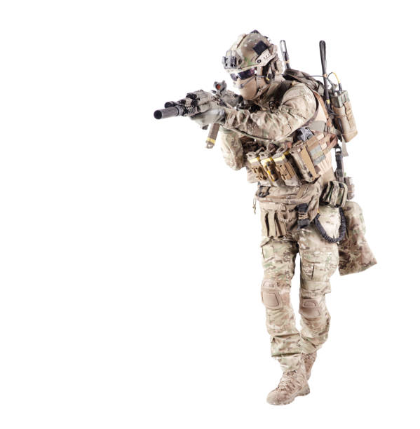 Equipped army soldier aiming rifle studio shoot stock photo