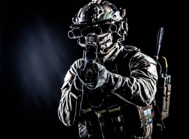 istock Army soldier aiming rifle in camera in darkness 1190225188