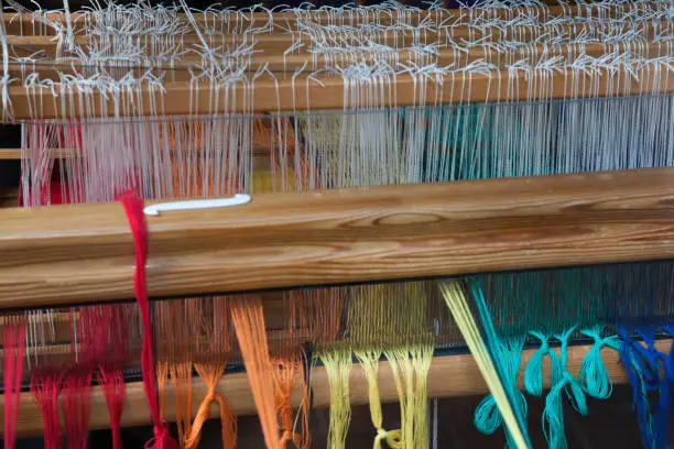 different colours of dread on a weaving-loom