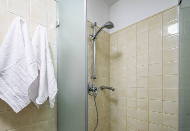 istock Opened shower cabin in modern bathroom. White towels. 1190227473