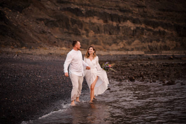 istock Happy couple having fun on a seashore 1190230262