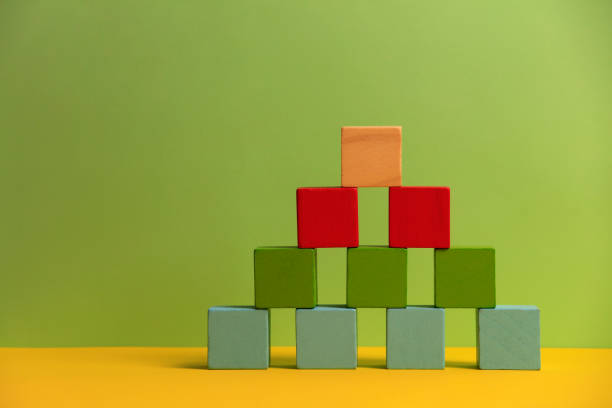 istock Wooden blocks on green background 1190232116