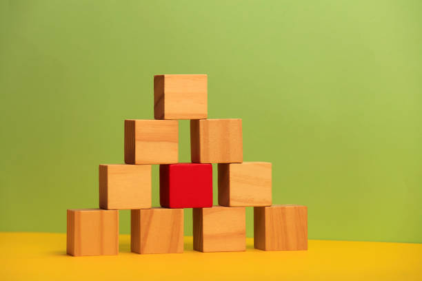 istock Wooden blocks on green background 1190232155
