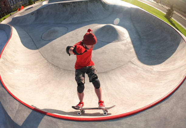 istock Skateboarder riding skateboard in skatepark pool 1190232212