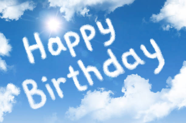 istock Happy birthday cloud words in the sky with a bright sun. 1190233455