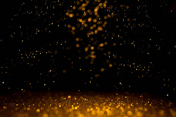 istock Golden abstract bokeh on black background. 1190233541