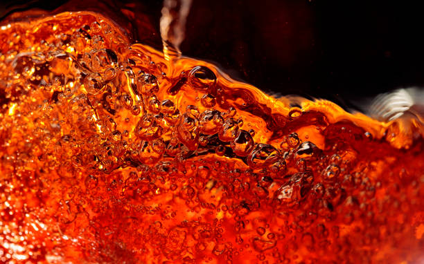 istock Alcoholic drink on a dark background, abstract splashing. 1190236436