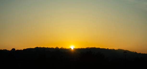 istock Sunset over hills, clear orange color sky background 1190237978