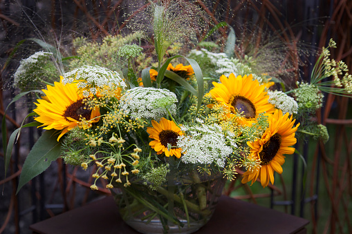 Autumnal bouquet with sunflowers in a glass vase