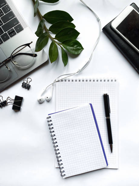 istock Desk with laptop, eye glasses, pen and workbooks. Top view with copy space. 1190241701