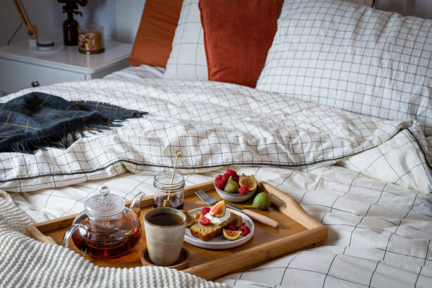 istock Breakfast in bed with pastry and fresh fruits, black tea 1190242793