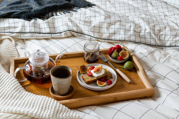 istock Breakfast in bed with pastry and fresh fruits, black tea 1190242955