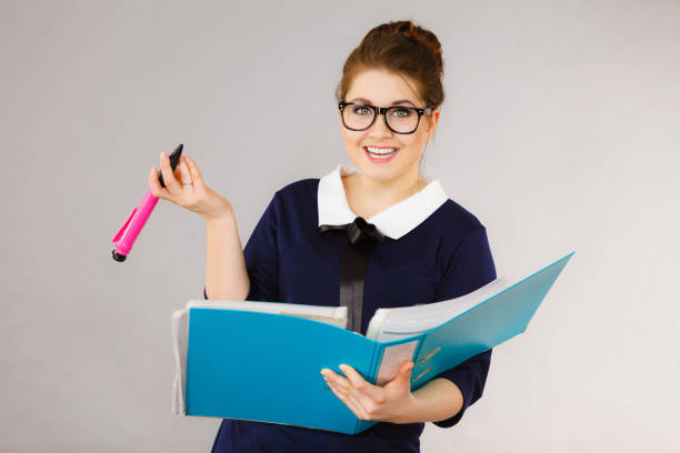 istock Happy positive business woman holding binder with documents 1190243046