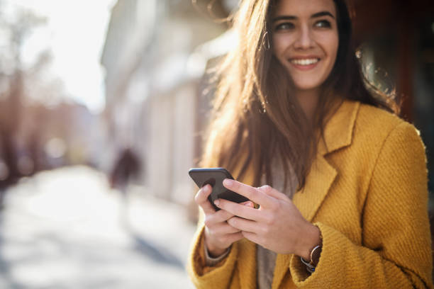 istock Portrait of a beautiful woman using a mobile 1190245156