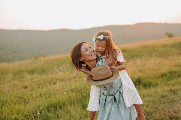 istock Mom playing with her daughter outdoors in the park. 1190246656