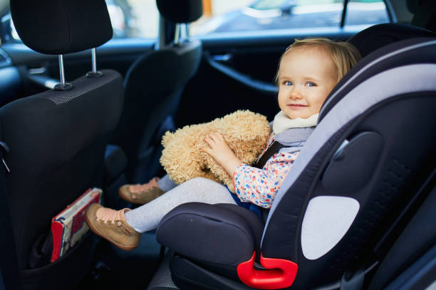 adorable toddler girl in modern car seat - car baby baby car seat child imagens e fotografias de stock
