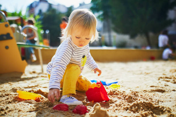istock girl on playground in sandpit 1190247415