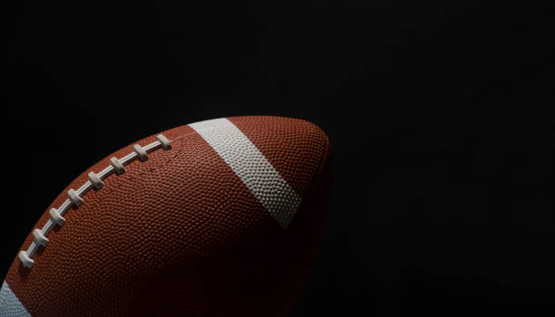 American football ball close up on black background. American football ball close up on black background. pigskin stock pictures, royalty-free photos & images