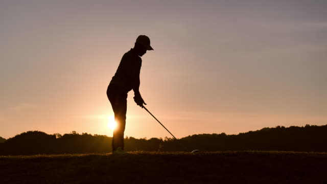 silhouette of golfers hit sweeping and keep golf course in the summer for relax time, sport concept.