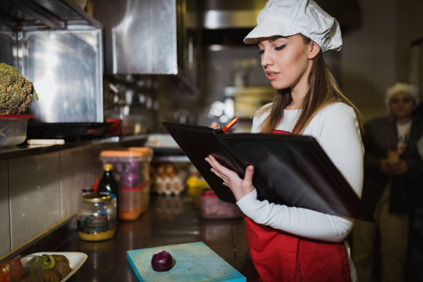 istock Woman making a menu in the restaurant kitchen 1190258597