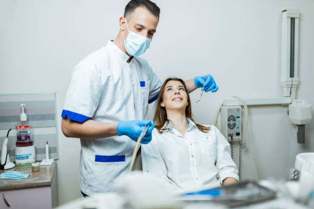 istock Male dentist examining patient's teeth in the office 1190258903