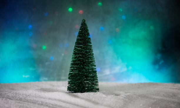 istock Empty space for your text. Christmas decorations. Fir tree standing on snow with beautiful holiday decorated background and traditional holiday attributes. Selective focus 1190262692