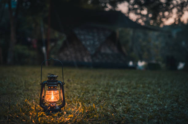istock vintage lantern on the grass while camping in the evening 1190263502