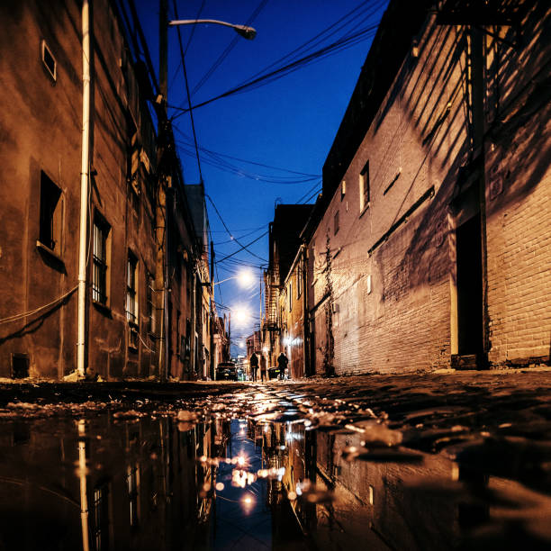 istock Dark alley reflected in puddle - Hoboken, NJ 1190265515