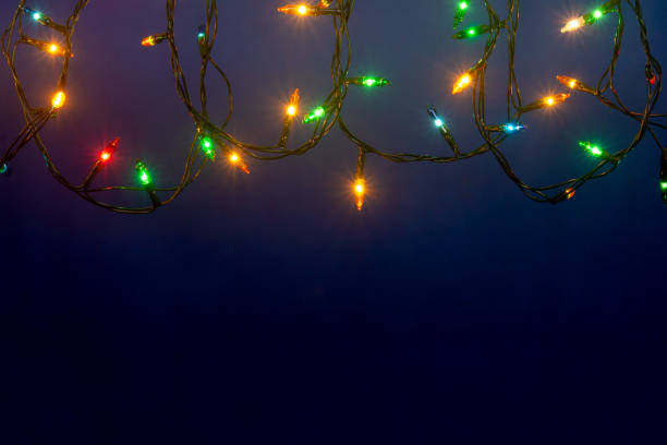 istock Christmas lights on blue background with copy space 1190273122