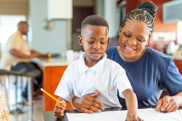 istock Mother Helping Her Son Do Homework at the Dining Room Table 1190274452