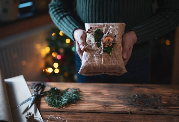 istock Man Holding Organic Christmas Gift. 1190277133