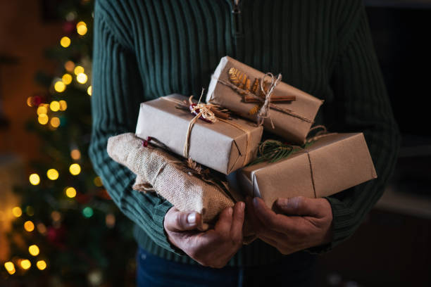 istock Man Holding Organic Christmas Presents. 1190277134