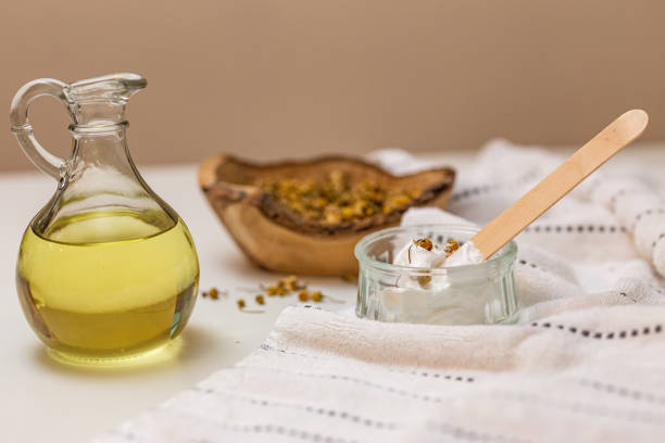 Homemade moisturizer Homemade made moisturizer and castor oil and chamomile around it castor oil stock pictures, royalty-free photos & images