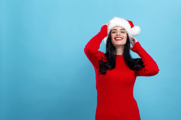 istock Happy woman with a Santa hat 1190289566