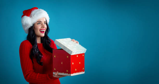 istock Young woman opening a Christmas gift box 1190289579