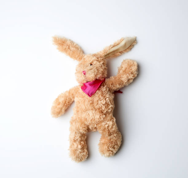 istock toy brown plush hare lies on a white background 1190294996